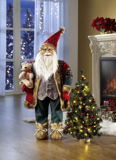 Weihnachtsmann mit beleuchtetem Weihnachtsbaum 